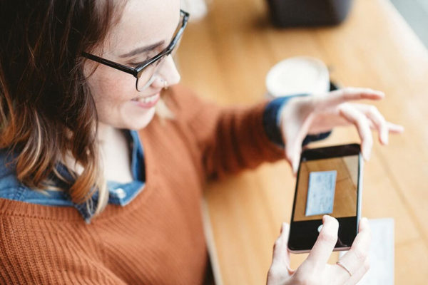 Woman scanning paycheck