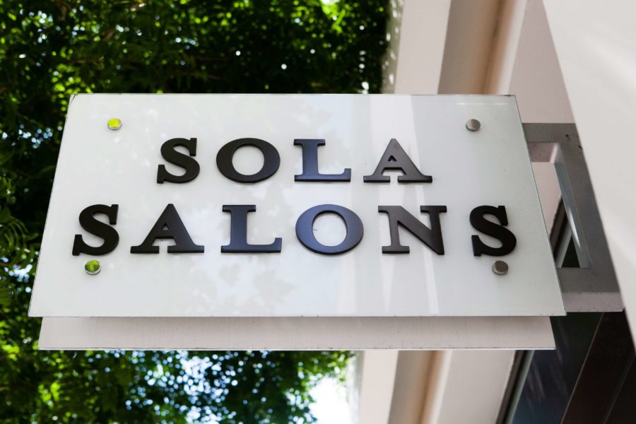 Signage out front of Sola Salon Studios